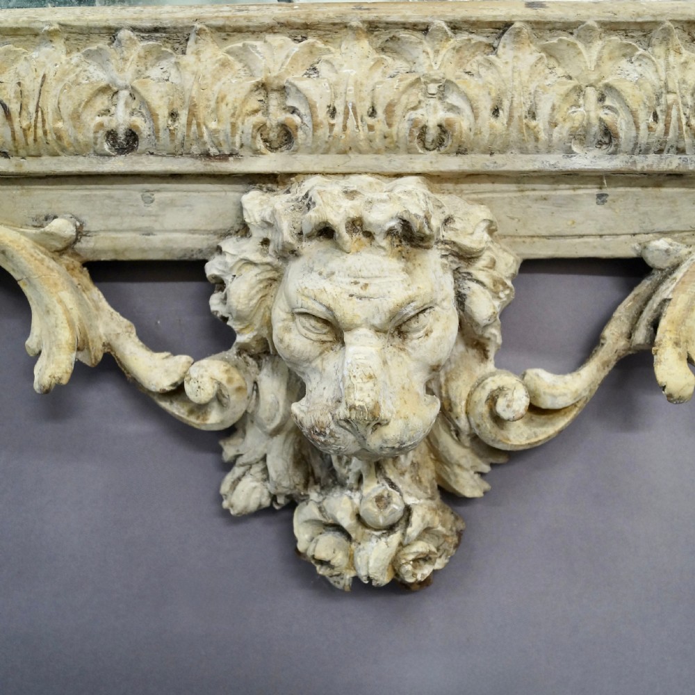 An eighteenth-century carved Italian wall mirror with a lyre crest motif, floral details, distressed off-white finish, and a lion mask base. View III