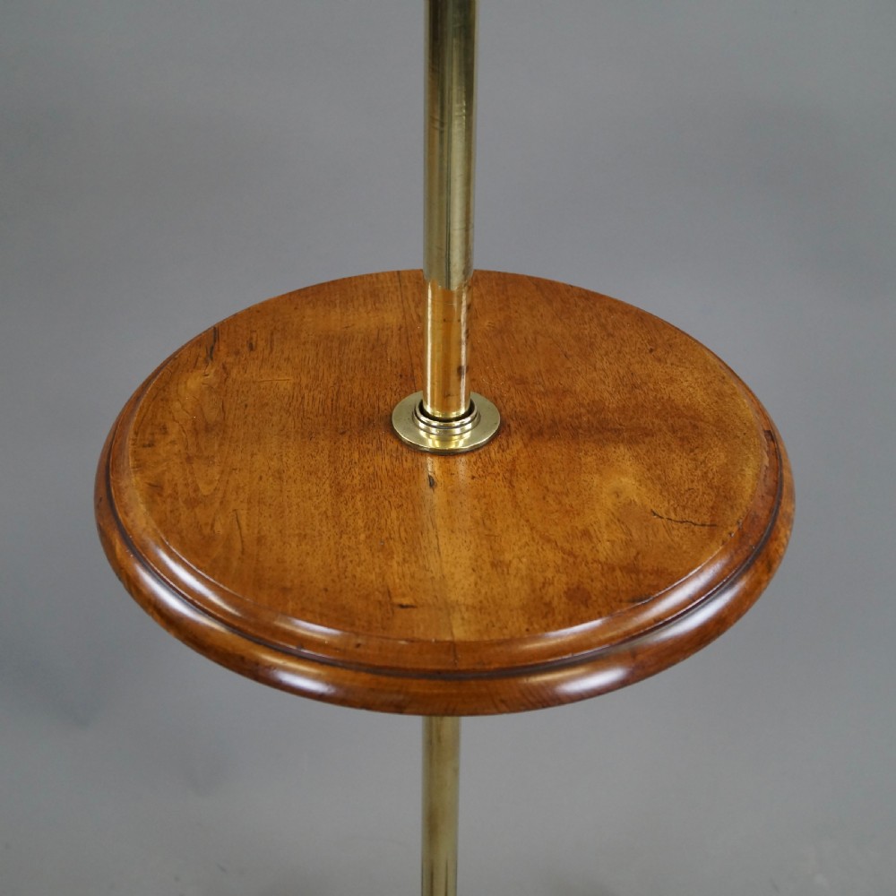 A late 19th-century Victorian reading stand with an adjustable brass stem, articulated arm holding a tilted mahogany book rest, a small central round mahogany shelf, and an ornate cast base. View III
