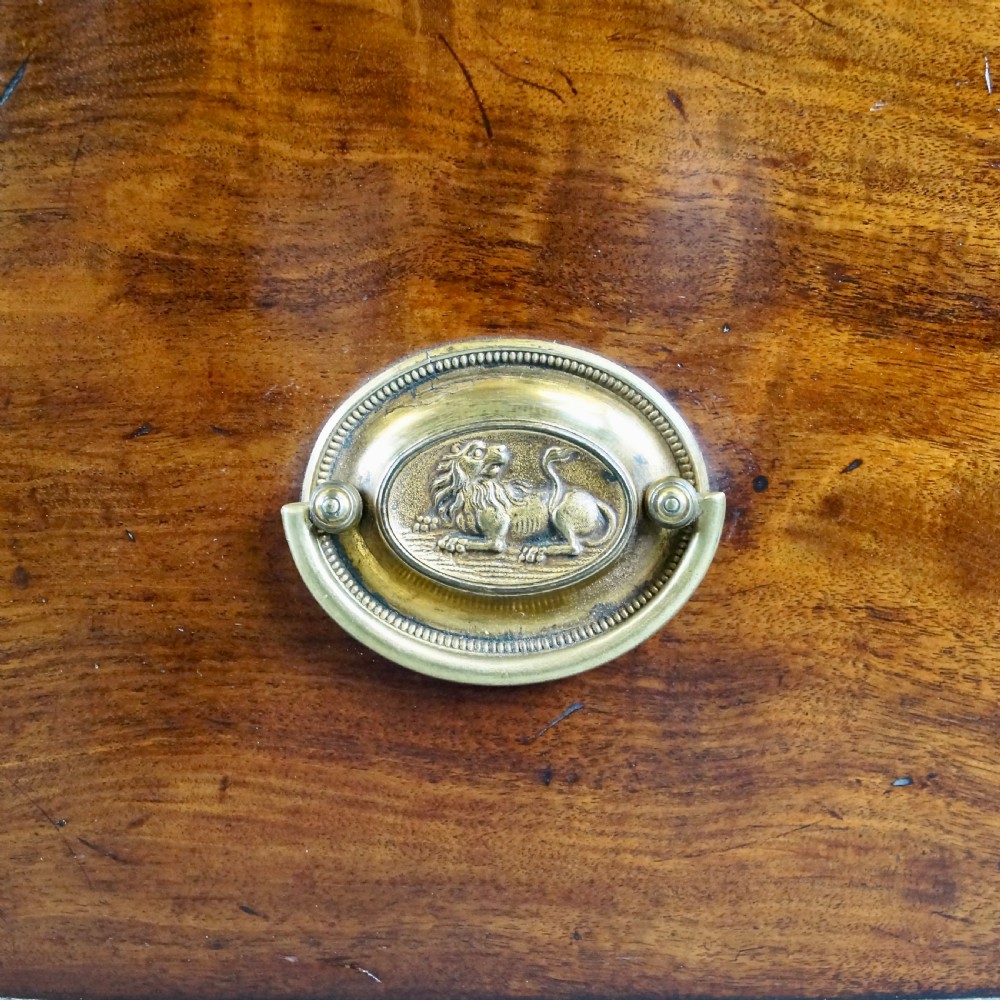 A George III mahogany bow-fronted chest of drawers featuring three graduated drawers with brass oval handles, a upper brushing slide, and splayed bracket feet. View III