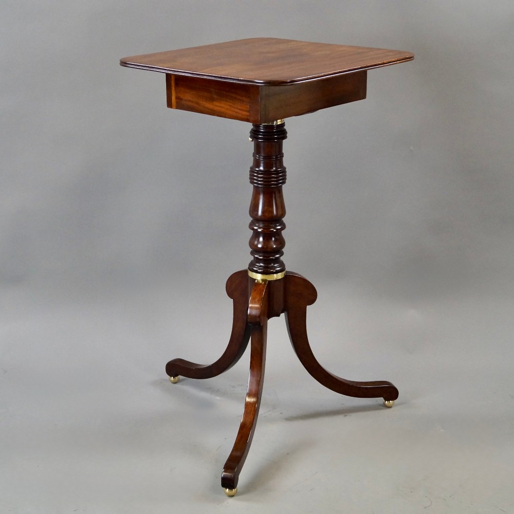 An antique Regency mahogany reading stand featuring an adjustable tilting book rest, turned central stem, brass accents, and sweeping tripod legs. View II