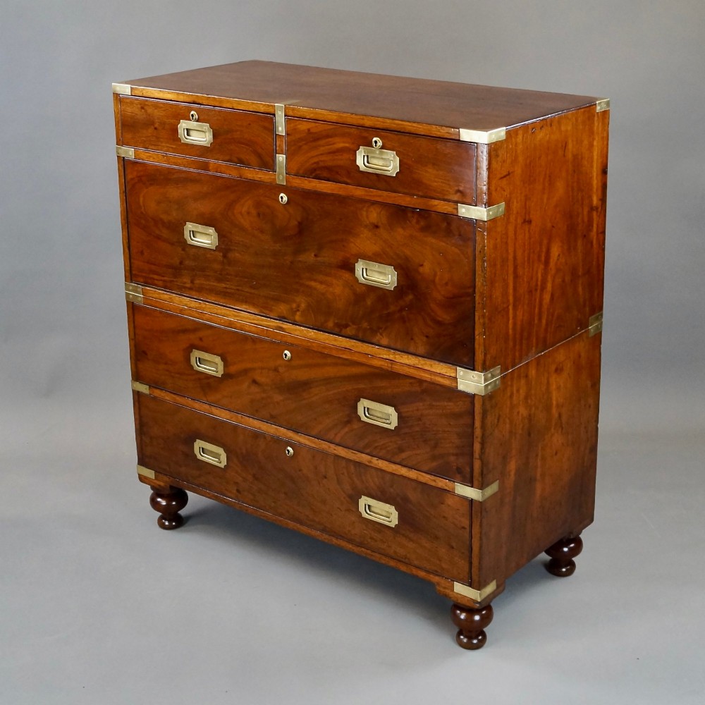 A nineteenth-century mahogany campaign chest of drawers featuring brass corner straps, flush recessed handles, and turned feet. View II