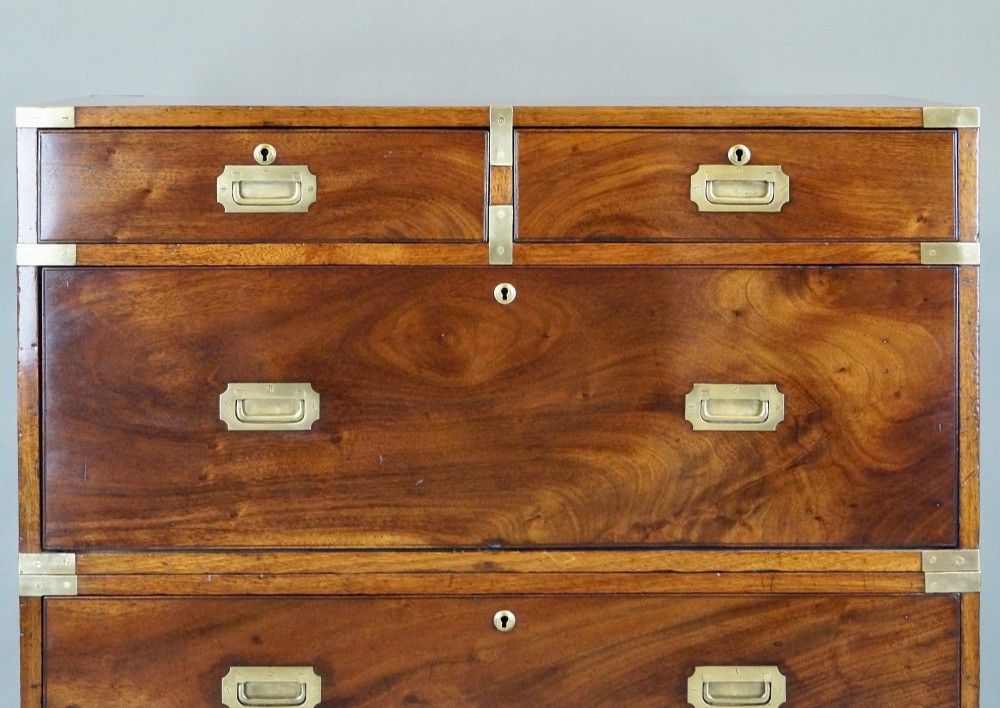 A nineteenth-century mahogany campaign chest of drawers featuring brass corner straps, flush recessed handles, and turned feet. View III