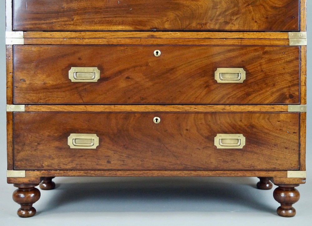 A nineteenth-century mahogany campaign chest of drawers featuring brass corner straps, flush recessed handles, and turned feet. View IV