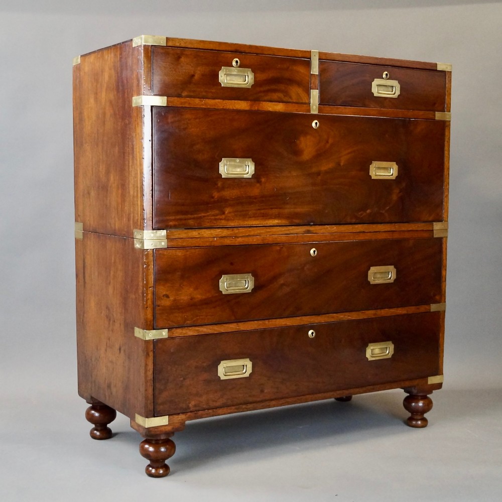 A nineteenth-century mahogany campaign chest of drawers featuring brass corner straps, flush recessed handles, and turned feet. View VI