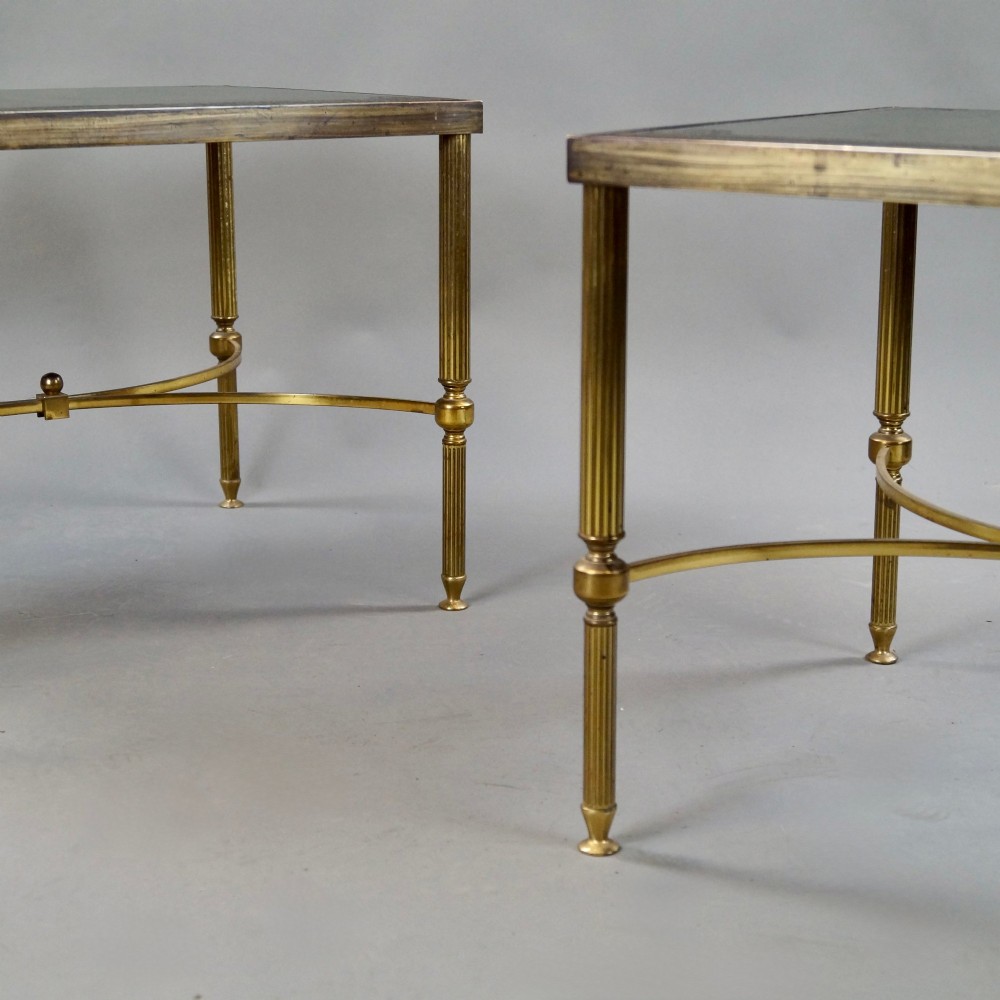 A pair of Neoclassical brass side tables with fluted legs, X-form stretchers, and green leather tops featuring gold tooling. View II