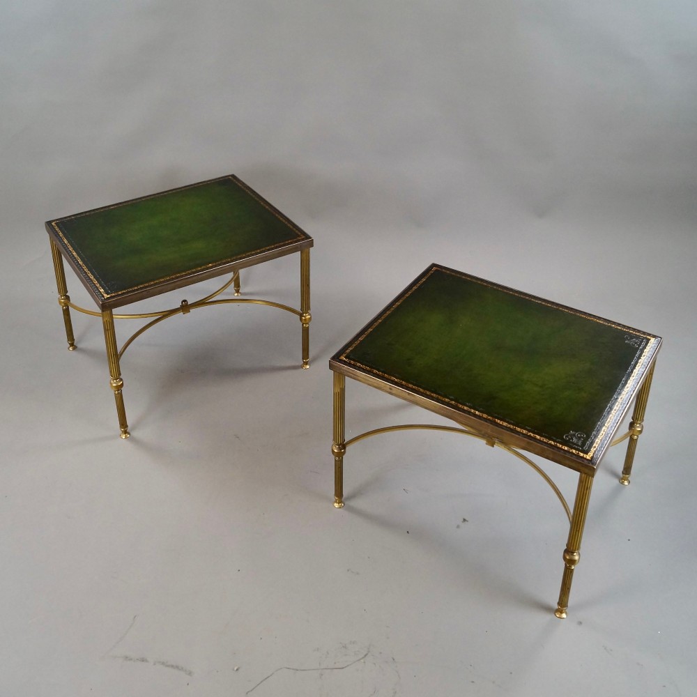 A pair of Neoclassical brass side tables with fluted legs, X-form stretchers, and green leather tops featuring gold tooling. View III