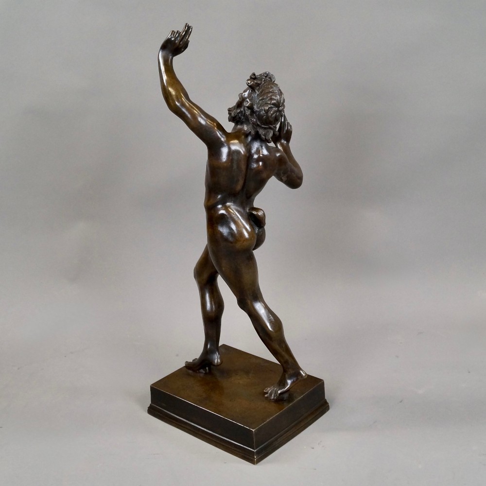 A late nineteenth-century dark brown patinated bronze sculpture depicting a dancing faun on a square plinth base. View V