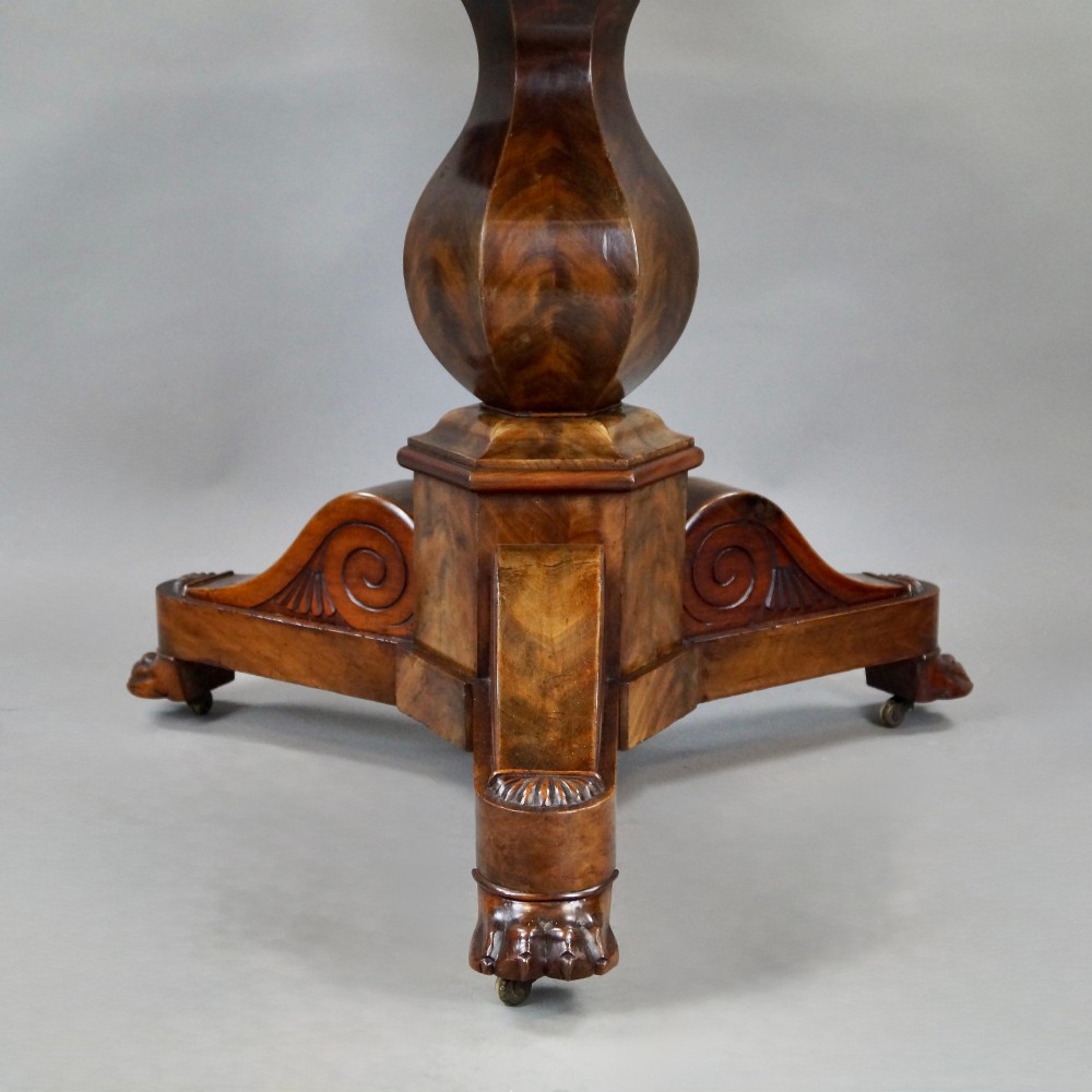 A 19th-century French circular gueridon centre table featuring a flame mahogany veneer pedestal base and a grey veined marble top resting on a triform plinth. View III