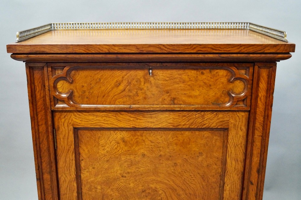 A pair of warm brown Gothic Revival wooden side cabinets featuring carved top drawers, single panel doors, and brass gallery rails along the tops. View II