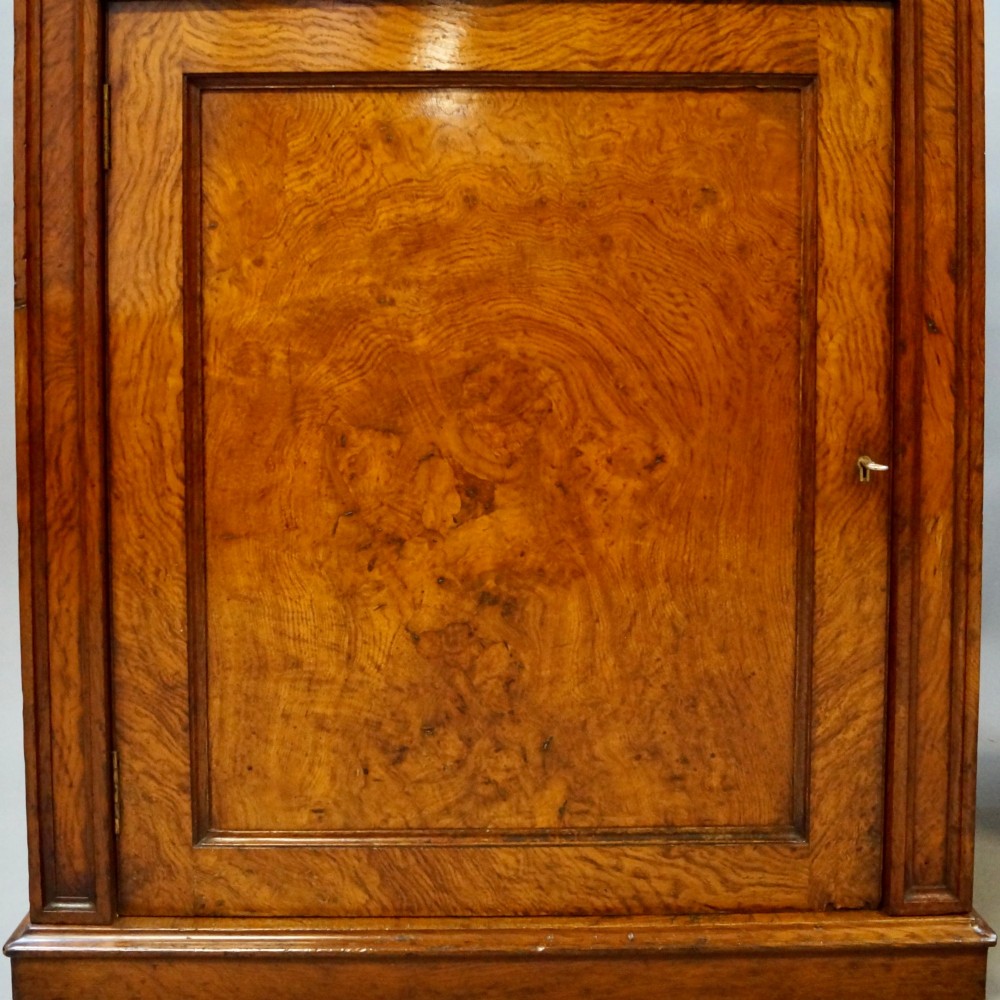 A pair of warm brown Gothic Revival wooden side cabinets featuring carved top drawers, single panel doors, and brass gallery rails along the tops. View V