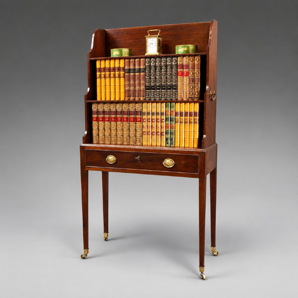 A George III mahogany waterfall bookcase with graduated open shelves, a single base drawer, side brass handles, and tapered square legs on castors.