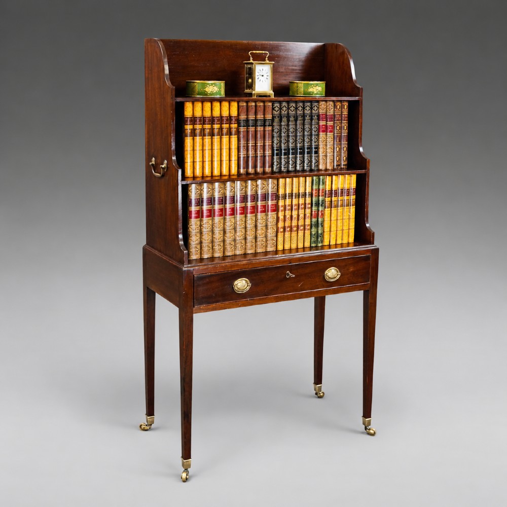 A George III mahogany waterfall bookcase with graduated open shelves, a single base drawer, side brass handles, and tapered square legs on castors. View III