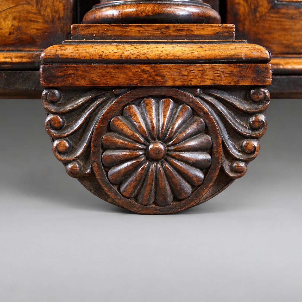 A Regency four-door rosewood side cabinet with a white marble top, carved columns, and brass lattice panels over fabric doors. View II