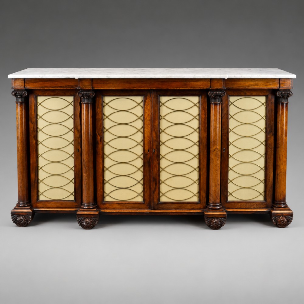 A Regency four-door rosewood side cabinet with a white marble top, carved columns, and brass lattice panels over fabric doors. View V