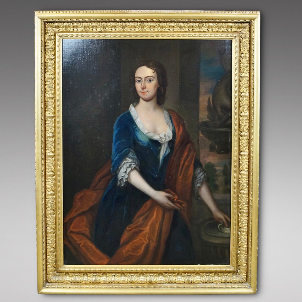 An 18th-century oil portrait depicting a lady in a blue dress and terracotta shawl seated beside a stone fountain detail. View II