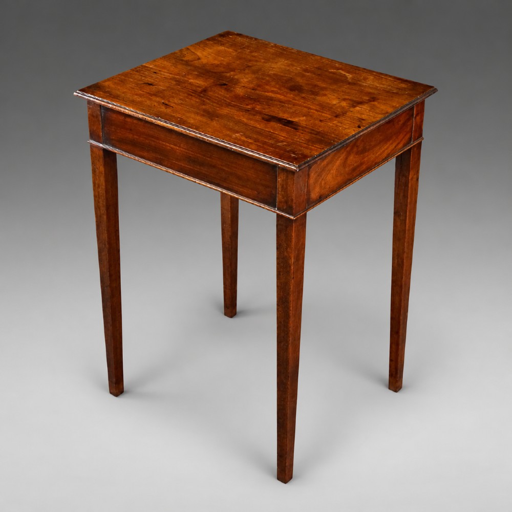 A rectangular George III mahogany side table featuring four straight tapered square legs and a polished wooden surface.