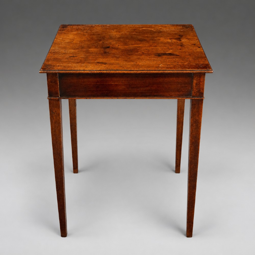 A rectangular George III mahogany side table featuring four straight tapered square legs and a polished wooden surface. View III