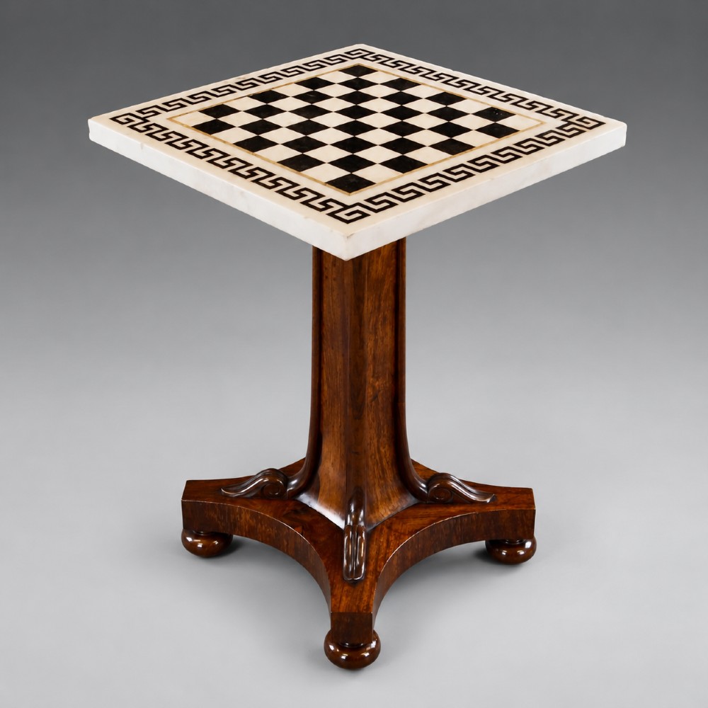 A Regency rosewood chess table featuring a square white and black marble inlaid chessboard top with a Greek key border set upon a flared central pedestal and quadripartite base.