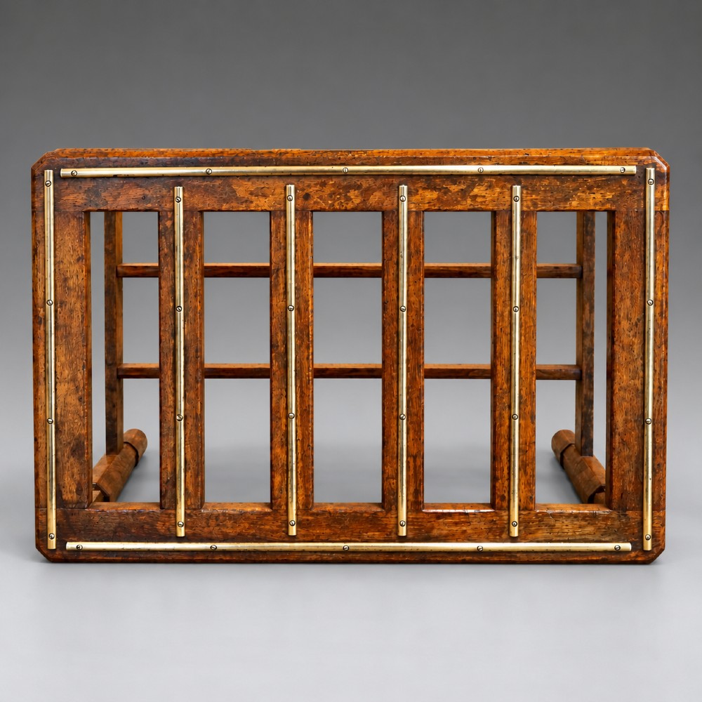 A late nineteenth-century oak luggage stand featuring brass-capped top slats, turned legs, and lower H-stretchers against a grey background. View III
