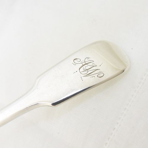 fig 1. An early Victorian sterling silver sugar shovel with a shaped rectangular shovel bowl and an engraved monogram on the flat handle.