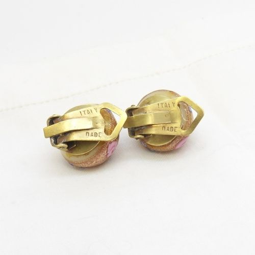 A pair of circular Italian wedding cake glass clip-on earrings featuring cream bases adorned with gold aventurine swirls and applied pink glass roses. View IV