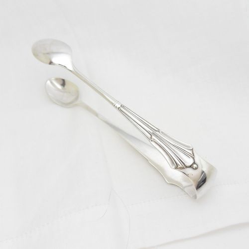 A pair of Victorian sterling silver sugar tongs in the Albany pattern with spoon-shaped ends and visible hallmarks. View IV