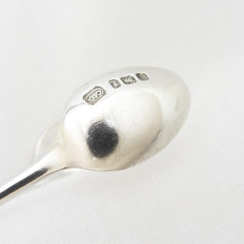 A pair of Victorian sterling silver sugar tongs in the Albany pattern with spoon-shaped ends and visible hallmarks. View VI