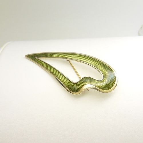 An asymmetric leaf-shaped brooch decorated with green guilloche enamel set within a gilded sterling silver frame. View V