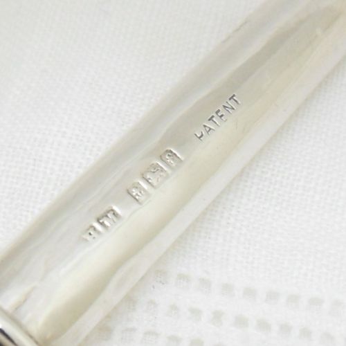 fig 1. An Edwardian sterling silver cylindrical posy holder featuring a flared rim and a small attachment loop.