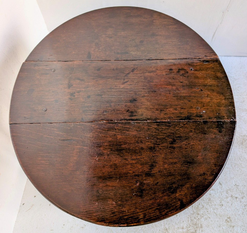 A dark oak 17th-century gateleg table with two drop-leaf flaps, turned baluster legs, and low box stretchers. View VIII