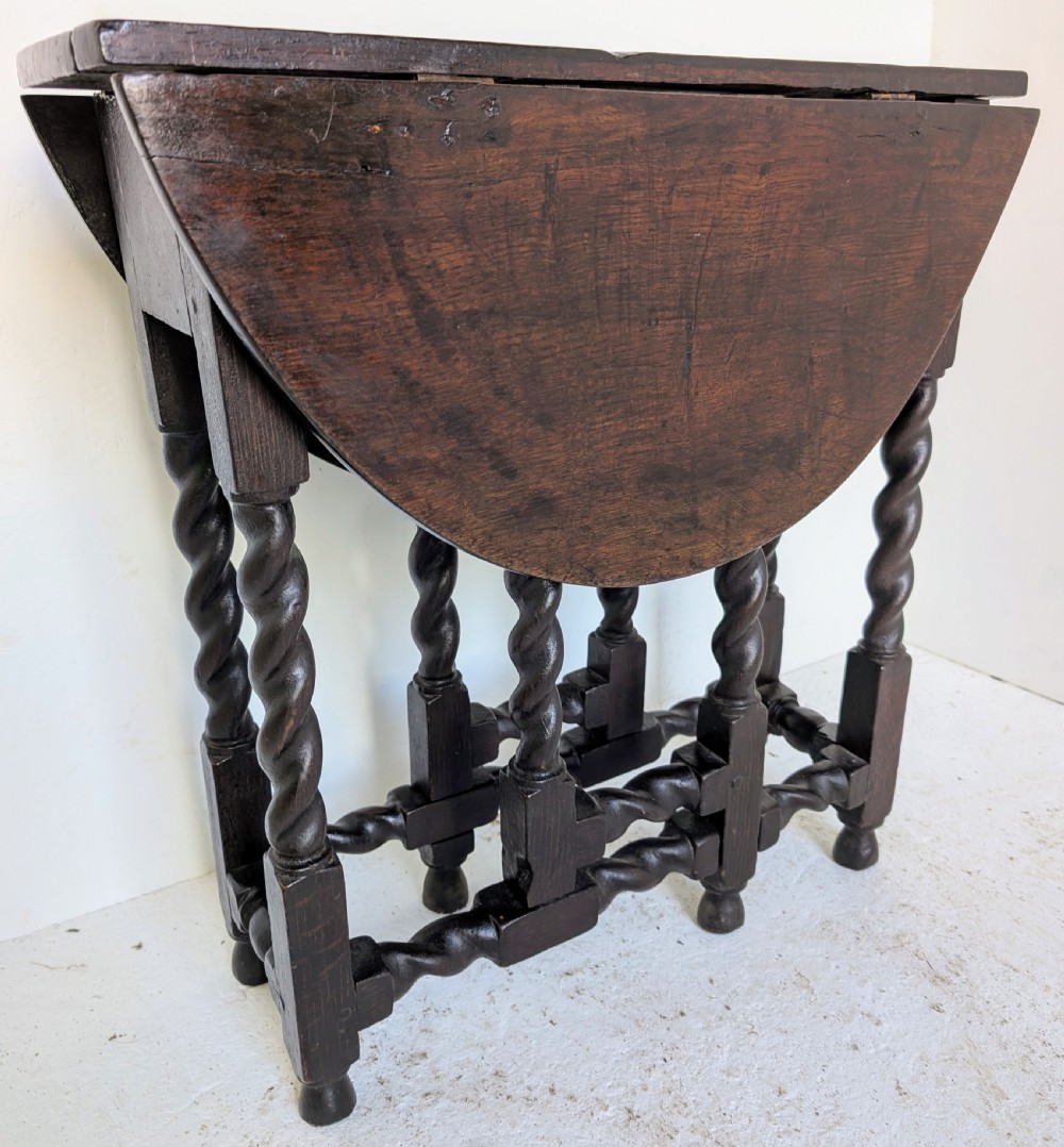 A small dark oak gateleg table featuring a drop-leaf top, barley twist legs, and lower connecting stretchers. View IV