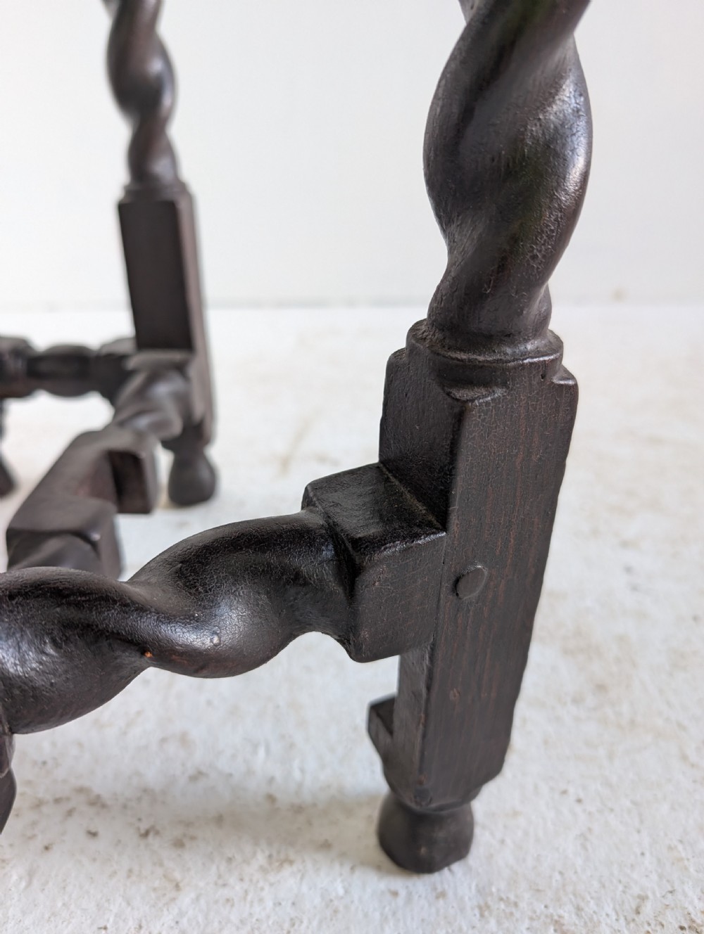 A small dark oak gateleg table featuring a drop-leaf top, barley twist legs, and lower connecting stretchers. View VII