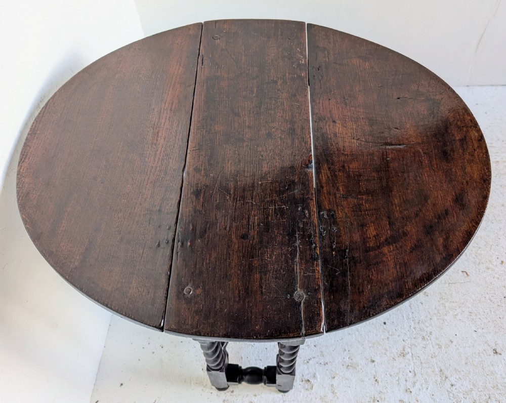 A small dark oak gateleg table featuring a drop-leaf top, barley twist legs, and lower connecting stretchers. View VIII