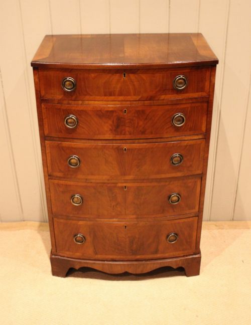 WALNUT BOW FRONT CHEST OF DRAWERS