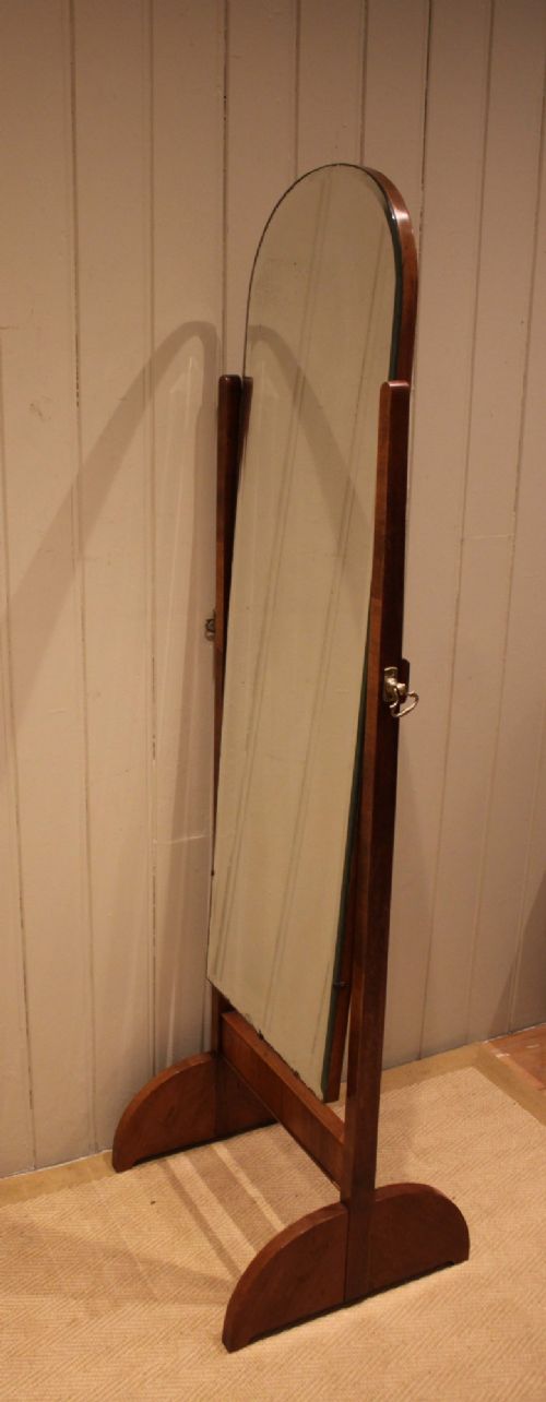 fig 1. An Art Deco freestanding walnut cheval mirror featuring an arched glass plate set within a timber stand.