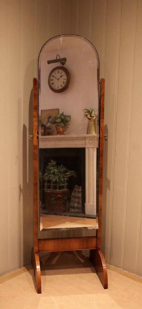 An Art Deco freestanding walnut cheval mirror featuring an arched glass plate set within a timber stand. View III