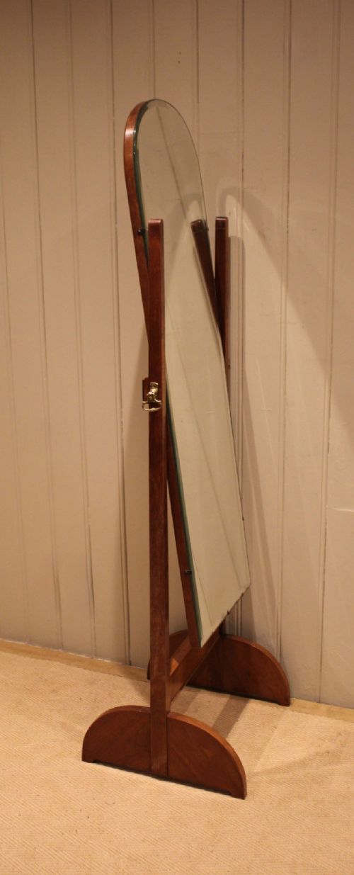An Art Deco freestanding walnut cheval mirror featuring an arched glass plate set within a timber stand. View IV