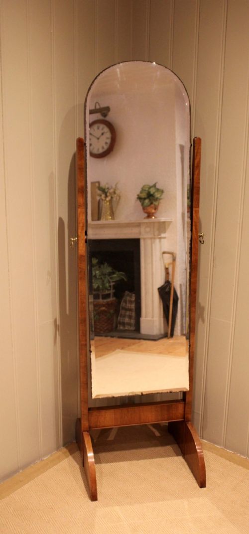 An Art Deco freestanding walnut cheval mirror featuring an arched glass plate set within a timber stand. View V