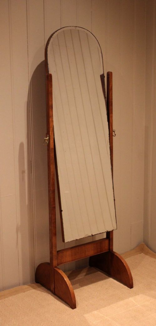 An Art Deco freestanding walnut cheval mirror featuring an arched glass plate set within a timber stand. View VI