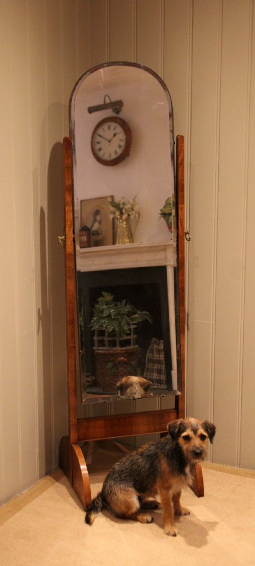 An Art Deco freestanding walnut cheval mirror featuring an arched glass plate set within a timber stand. View VII