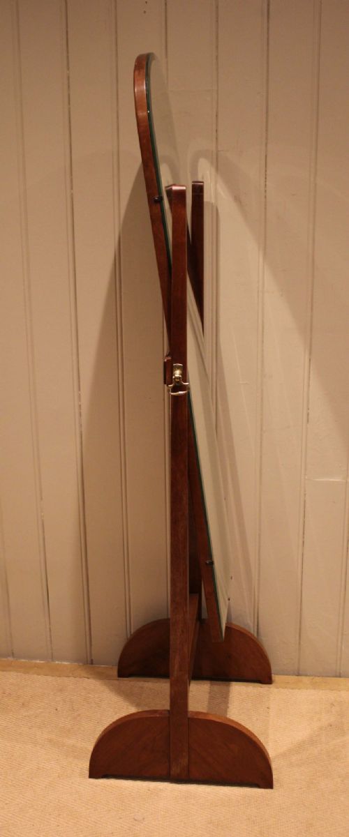 An Art Deco freestanding walnut cheval mirror featuring an arched glass plate set within a timber stand. View VIII