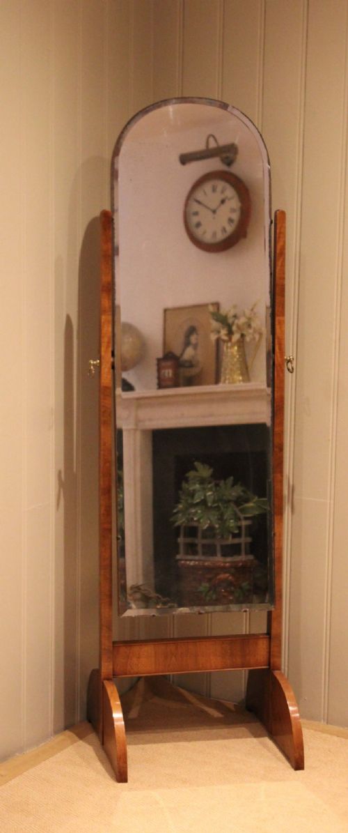 An Art Deco freestanding walnut cheval mirror featuring an arched glass plate set within a timber stand. View X