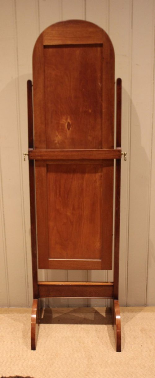 An Art Deco freestanding walnut cheval mirror featuring an arched glass plate set within a timber stand. View XI