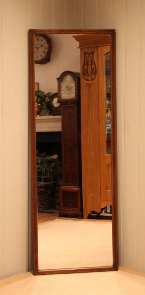 A large rectangular full-length mirror featuring a slender moulded oak frame with visible natural grain. View II