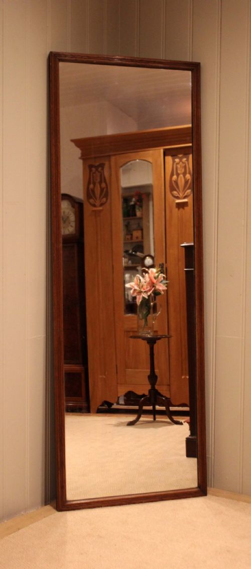 A large rectangular full-length mirror featuring a slender moulded oak frame with visible natural grain. View VI