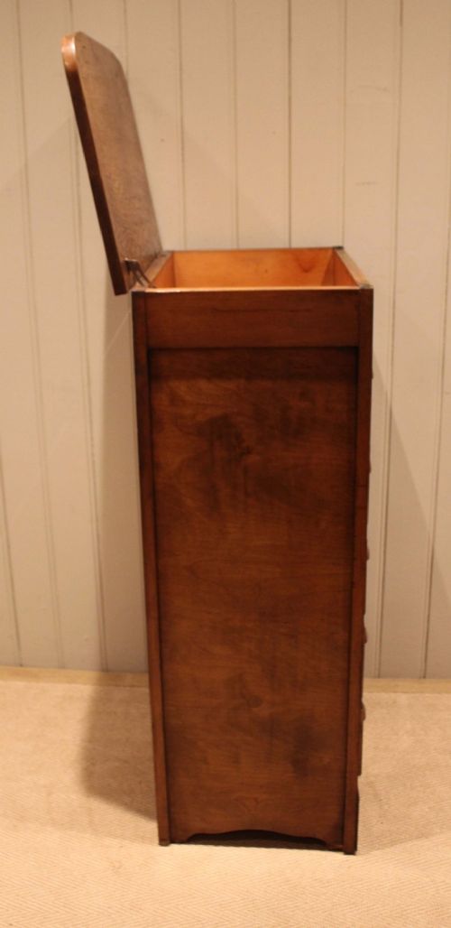 A tall oak chest of drawers featuring five drawers with metal cup handles and reeded side detailing. View XI
