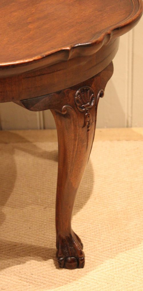 A low mahogany coffee table featuring a shaped piecrust rim, carved cabriole legs with shell knee detailing, and claw and ball feet. View IX