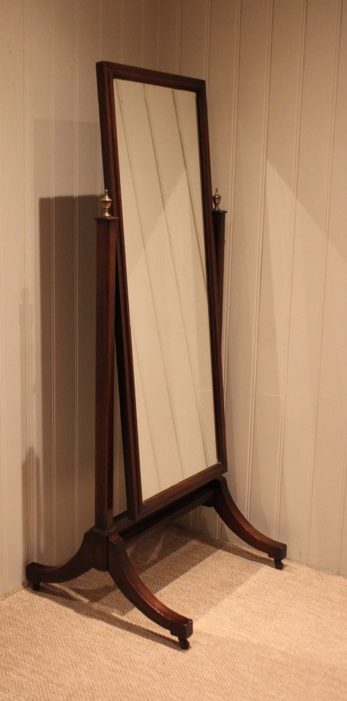 A late nineteenth-century mahogany cheval mirror featuring a rectangular swinging glass frame supported by upright pillars on splayed feet with brass castors. View III