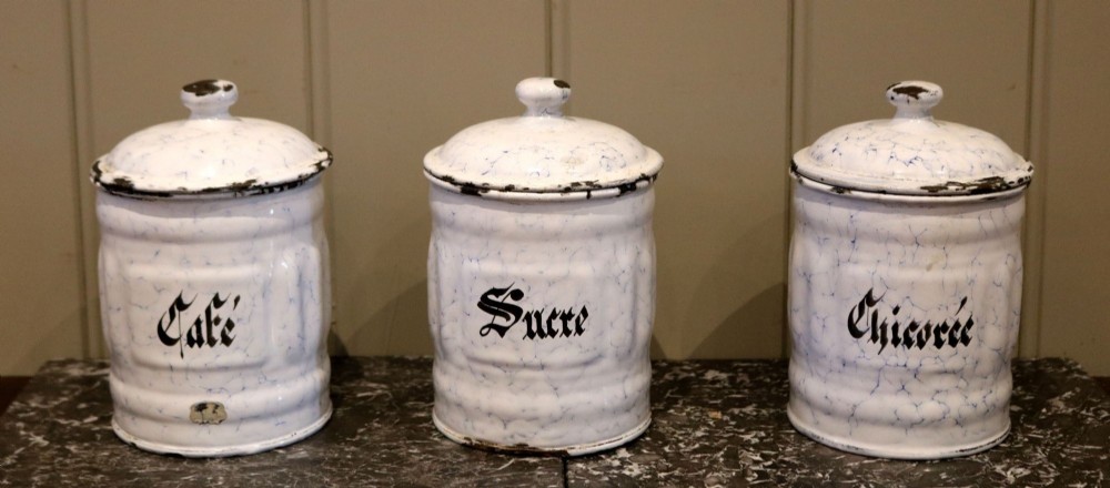 A set of three antique marbled blue and white French enamel kitchen canisters featuring Gothic script for Cafe, Sucre, and Chicoree.
