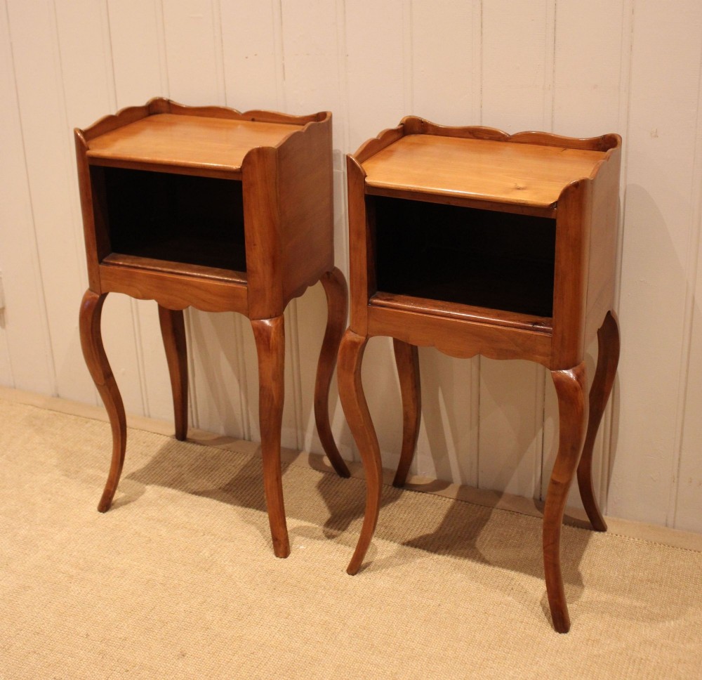 A pair of warm brown cherry wood bedside cabinets featuring open shelf compartments, scalloped top galleries, and slender cabriole legs. View IV